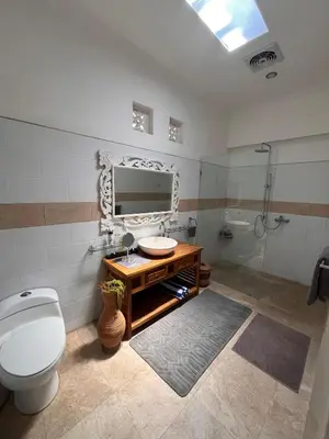 a bathroom with a toilet and a sink and a shower at Villa Harmony Moon in Seminyak