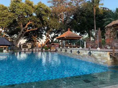 a swimming pool at a resort with a gazebo at The Jayakarta Residence 2BR Bali in Denpasar