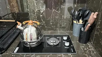 a tea kettle sitting on top of a stove at Banana Room Near to Kuta Legian Beach in Legian