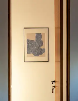 a picture hanging on a wall next to a door at Villa Semilir Sendja, Canggu in Canggu