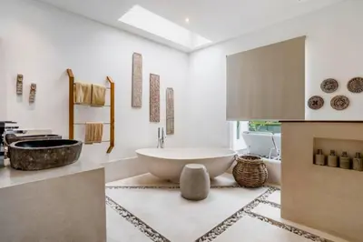 a bathroom with a large tub and a sink at Feodora Peaceful 4 BR Private Pool Villa in Seminyak
