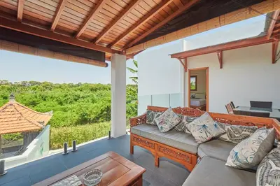 a living room with a couch and a table at Villa Kartini - Two Bedrooms in Legian