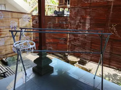 a glass table with a white chair on a glass floor at Kuta Grace house Bali in Kuta
