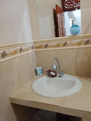 a bathroom with a white sink and a mirror at Kuta Grace house Bali in Kuta