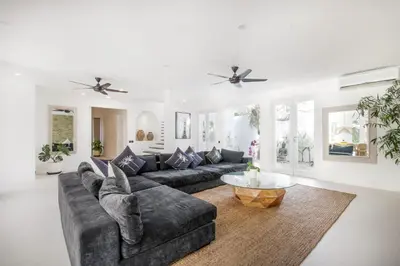 a living room with a couch and a table at Villa Stella Belle Seminyak in Seminyak