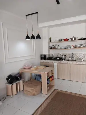 a kitchen with a table and a counter in it at Villa 1 Kavi minimalis 1 Kamar di Sanur in Sanur