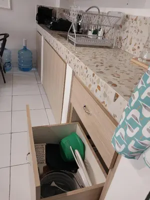 a kitchen counter with a drawer filled with dishes at Villa 1 Kavi minimalis 1 Kamar di Sanur in Sanur