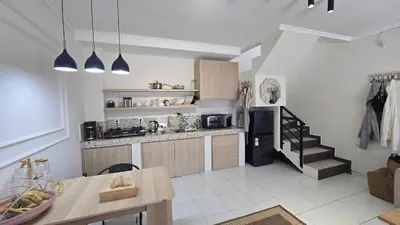 a kitchen with a counter and a staircase in a room at Villa 1 Kavi minimalis 1 Kamar di Sanur in Sanur
