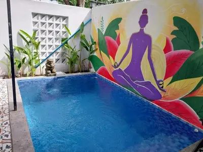 a mural of a woman in a yoga pose on a wall at Villa 2 Kavi Minimalis 1 Kamar Di Sanur in Sanur