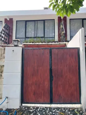 a wooden gate in front of a house at Villa 2 Kavi Minimalis 1 Kamar Di Sanur in Sanur