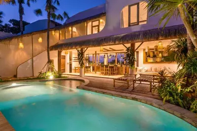 a swimming pool in front of a house at Adena Modern Paradise 3 BR Private Pool Villa in Kerobokan