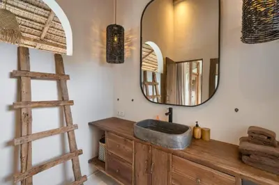 a bathroom with a sink and a mirror at Adena Modern Paradise 3 BR Private Pool Villa in Kerobokan