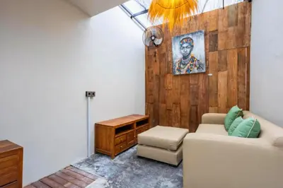 a living room with a couch and a table at Erianthe Peaceful 3 BR Private Pool Villa in Kerobokan