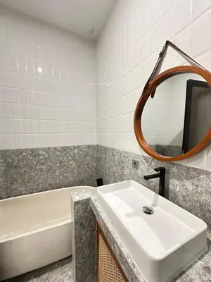 a bathroom with a sink and a tub and a mirror at Della Solea Seminyak in Seminyak