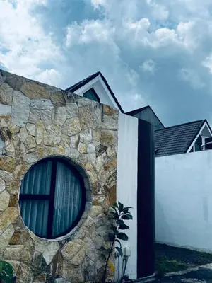 a building with a stone wall with a window at Della Solea Seminyak in Seminyak