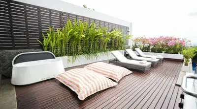 a balcony with white furniture and plants on it at Mahita Garden Villa 3 Bedroom with Amazing view in Jimbaran