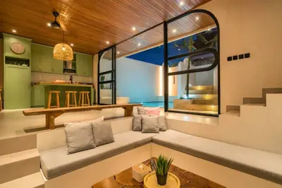a living room with a large window and a couch at Omarosa Stunning 3 BR Private Pool Villa in Kerobokan
