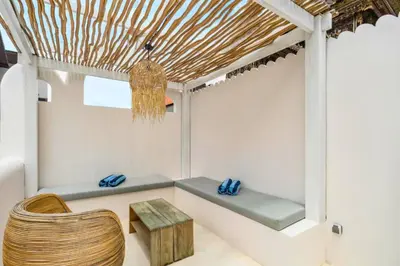 a room with a bench and a wooden table at Omarosa Stunning 3 BR Private Pool Villa in Kerobokan