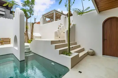 a house with a swimming pool and stairs at Omarosa Stunning 3 BR Private Pool Villa in Kerobokan