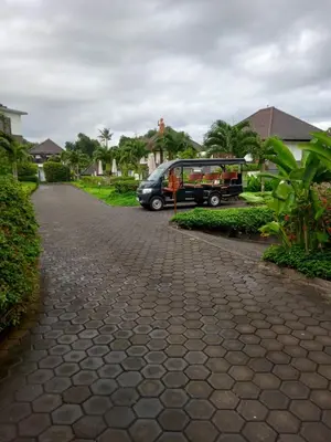 a van parked in a driveway next to a house at Joand Skyline in Seminyak