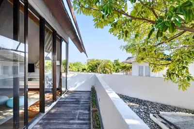 an external view of a house with glass windows at Sayara Modern 3 BR Private Pool Villa in Seminyak