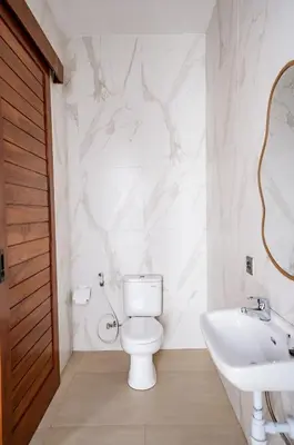 a bathroom with a toilet and a sink at Il Petrucino Villa by Damaresa in Nusa Dua