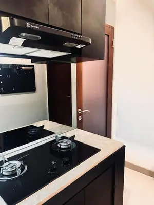 a kitchen with a black stove top oven at Casa Danasa, secure and serene Villa at the heart of Seminyak with 24hr One Gate Security in Seminyak
