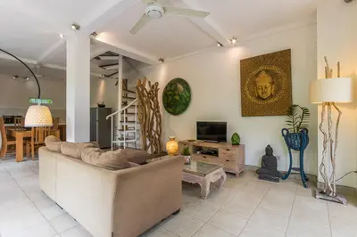 a living room with a couch and a tv at Villa emma, 2 bed with pool table & private pool in Seminyak