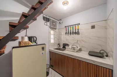 a kitchen with a refrigerator and a sink at Cozy Mezzanine Near Airport & Jimbaran Beach in Ngurah Rai International Airport
