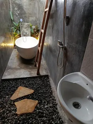 a bathroom with a sink and a toilet at Gusti Ayu Private Bali House - 2 Bedrooms near Canggu & Seminyak in Kerobokan