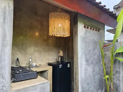 a kitchen with a stove and a refrigerator at Gusti Ayu Private Bali House - 2 Bedrooms near Canggu & Seminyak in Kerobokan