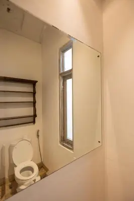 a mirror in a bathroom with a toilet at Charming Two Bedroom Villa Near Seminyak Beach in Seminyak