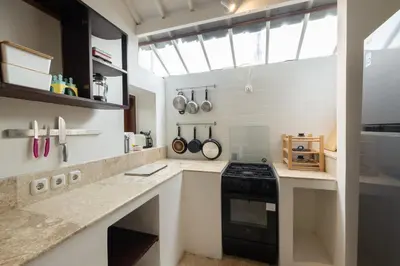 a kitchen with white counters and a black stove at Charming Two Bedroom Villa Near Seminyak Beach in Seminyak