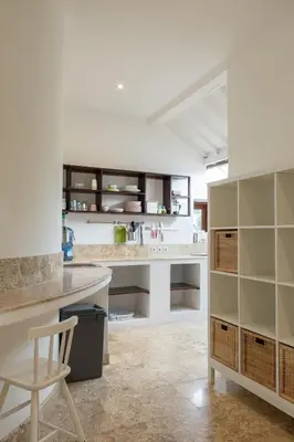 a kitchen with a counter and a stool in a room at Charming Two Bedroom Villa Near Seminyak Beach in Seminyak