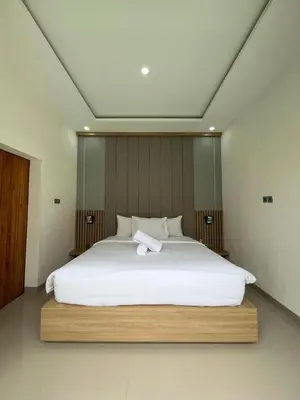a large white bed with a white towel on it at Ametys 1 Villa - Cozy 2BR Villa with Private Pool & Prime Seminyak in Seminyak
