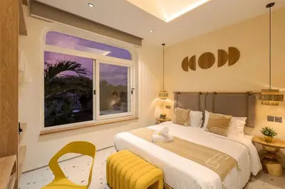 a bedroom with a large bed and a window at The Shalak Villa Bali in Denpasar