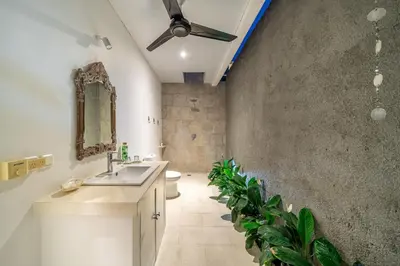 a bathroom with a sink and a toilet and plants at Villa GR888 - 3BR Tropical Comfort Seminyak in Seminyak