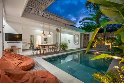 a villa with a swimming pool and a dining area at Villa GR888 - 3BR Tropical Comfort Seminyak in Seminyak