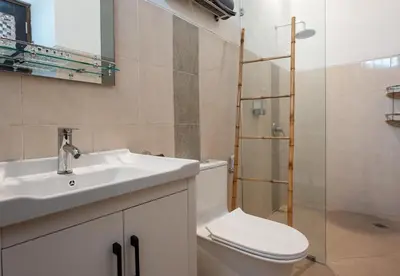 a bathroom with a sink and a toilet and a shower at 2BR Villa - Central Seminyak - Private Cook & Breakfast in Seminyak