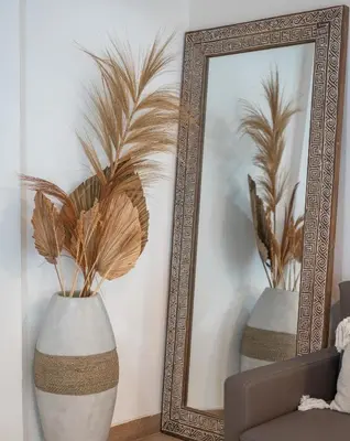 a mirror and a vase with plants in it at 2BR Villa - Central Seminyak - Private Cook & Breakfast in Seminyak