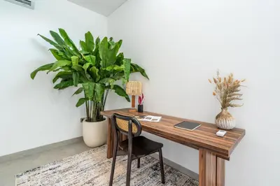 an office with a desk with a chair and plants at Villa Rice Kerobokan in Kerobokan