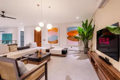 a living room with a couch and a tv at Villa Rice Kerobokan in Kerobokan