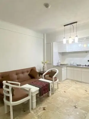 a living room with a couch and a table and chairs at The Beach Residence at Jayakarta Resort Bali in Seminyak
