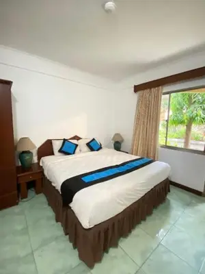 a bedroom with a large bed with a window at The Beach Residence at Jayakarta Resort Bali in Seminyak