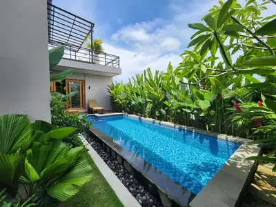 a swimming pool in front of a villa at Best Villa in Jimbaran
