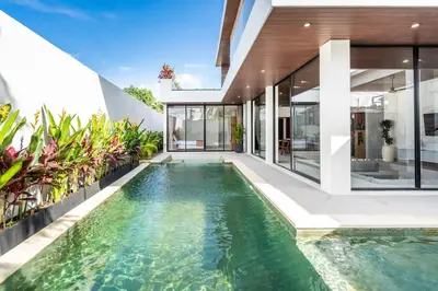 an infinity pool in the backyard of a house at New Villa 3BR Umalas Pool Near Seminyak and Canggu in Canggu