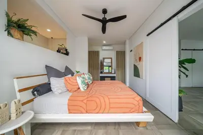 a bedroom with a bed and a ceiling fan at Villa 121 - Modern 1BR Villa Near Batu Belig Beach in Seminyak