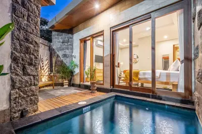 a house with a swimming pool and a bedroom at Semar Villa, a cozy studio Villa with a Private Pool, Bali in Legian