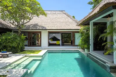 a swimming pool in front of a house at Superb and Elegant 3-Bedroom Villa Close to the Beach in Seminyak