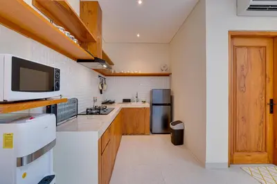 a kitchen with a sink and a refrigerator at Private 3BR Villa Sweetie with Pool Seminyak in Seminyak